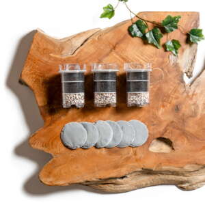 Lotus Vita ENYA half-year replacement bundle, including three filter cartridges and six filter pads, arranged on a rustic wood surface.